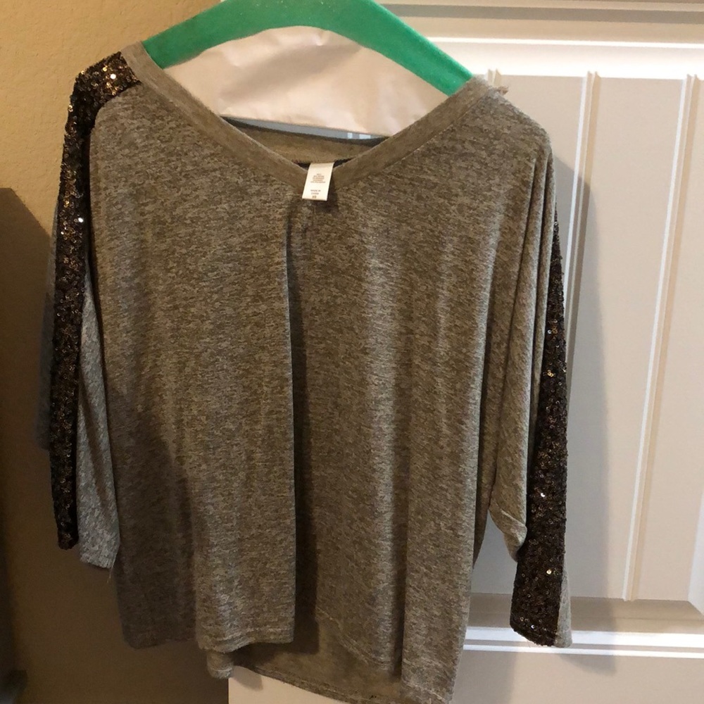grey shirt with sparkly sleeves